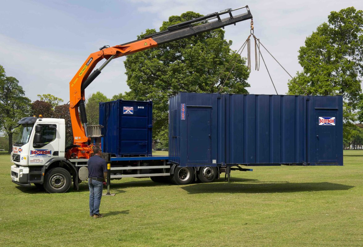 Container being lifted by a crane
